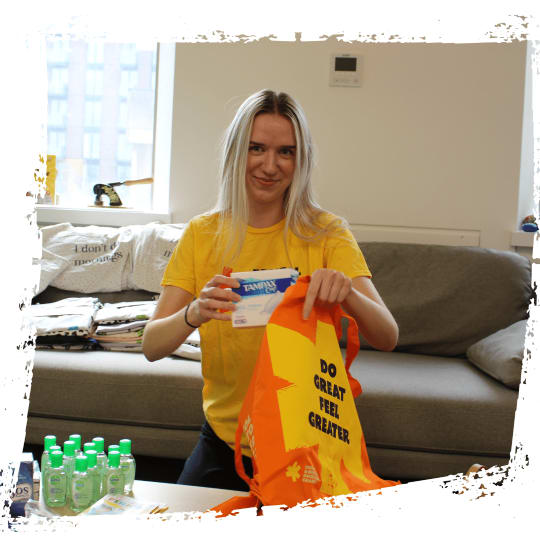 A member of staff packs period products into tote bags